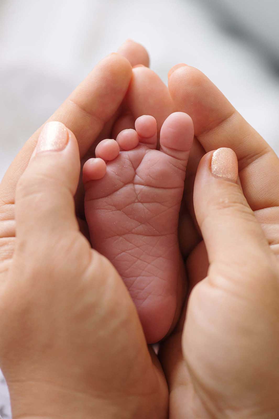 tiny-foot-of-a-newborn-baby-in-the-mother-s-palms-2023-11-27-05-34-06-utc